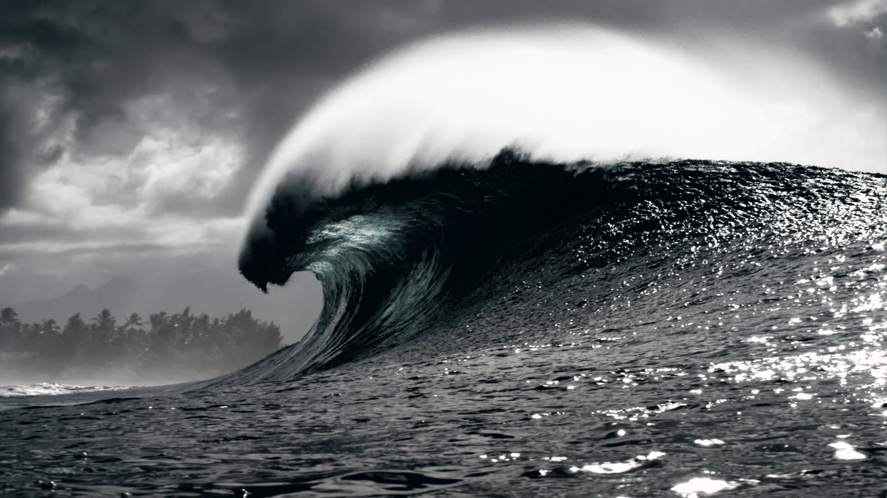 After: Bright blue wave is darked, image has changed to black and white.