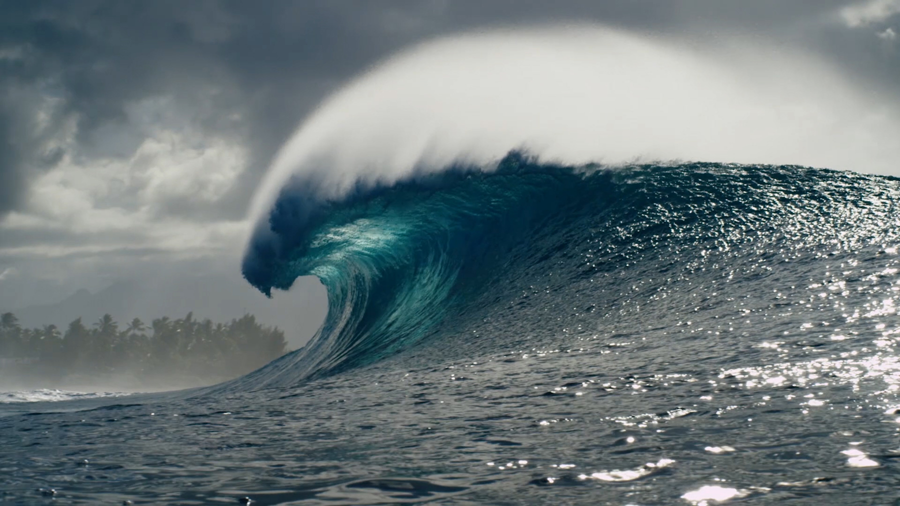 Before: Dark sea with bright blue wave and large white crest.